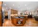 Open-concept kitchen with wooden cabinets, granite countertops, stainless appliances, and seamless flow to living room at 511 Pembroke Ln, Waxhaw, NC 28173