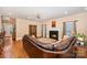Comfortable living room showcasing a fireplace, hardwood floors, and a ceiling fan at 511 Pembroke Ln, Waxhaw, NC 28173