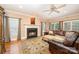 Inviting living room features a fireplace, hardwood floors, and comfortable, leather seating at 511 Pembroke Ln, Waxhaw, NC 28173