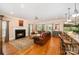 Bright and open living room featuring fireplace, hardwood floors, and seamless flow to the kitchen at 511 Pembroke Ln, Waxhaw, NC 28173
