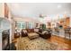 Open-concept living room with fireplace, hardwood floors, and seamless flow to the kitchen at 511 Pembroke Ln, Waxhaw, NC 28173