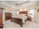 Spacious main bedroom featuring a tray ceiling, ceiling fan, and large bed with side tables at 511 Pembroke Ln, Waxhaw, NC 28173