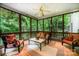 Inviting screened porch with comfortable seating, ceiling fan, and view of the surrounding trees at 511 Pembroke Ln, Waxhaw, NC 28173