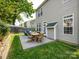 Private backyard with a patio, outdoor seating, and lush landscaping at 5304 Silabert Ave, Charlotte, NC 28205