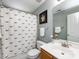 Neutral bathroom featuring a whale-themed shower curtain, vanity, and mirror at 5304 Silabert Ave, Charlotte, NC 28205
