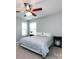 Light-filled bedroom features a ceiling fan, two windows, and neutral decor at 5304 Silabert Ave, Charlotte, NC 28205