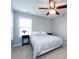 Bright bedroom featuring a ceiling fan, windows, and neutral decor at 5304 Silabert Ave, Charlotte, NC 28205