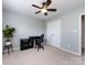 Neutral bedroom featuring a ceiling fan, work desk, and ample room for personalization at 5304 Silabert Ave, Charlotte, NC 28205