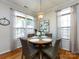 Dining room with a round table, four chairs, and large windows providing natural light at 5304 Silabert Ave, Charlotte, NC 28205