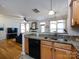 Kitchen with granite countertops, light wood cabinets, stainless steel sink, and views into the living room at 5304 Silabert Ave, Charlotte, NC 28205