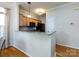 Kitchen featuring granite countertops and stainless steel appliances, with a breakfast bar and dining area nearby at 5304 Silabert Ave, Charlotte, NC 28205