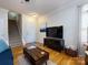 Comfortable living room with hardwood floors, a cozy couch and access to the home's staircase at 5304 Silabert Ave, Charlotte, NC 28205