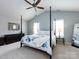 Spacious main bedroom features a four-poster bed, ample natural light, and vaulted ceiling at 5304 Silabert Ave, Charlotte, NC 28205
