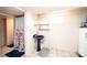 Bathroom with a floral shower curtain, pedestal sink, window, and tile floors at 542 9Th Nw St, Hickory, NC 28601