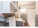 Bathroom with white cabinets and gray-and-pink retro tile surrounding the shower and sink at 542 9Th Nw St, Hickory, NC 28601