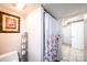 Cozy bathroom with a floral shower curtain, toilet, and toiletries holder at 542 9Th Nw St, Hickory, NC 28601