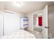 Cozy bedroom featuring sliding closet, vintage painted dresser, and entrance to the home at 542 9Th Nw St, Hickory, NC 28601
