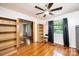 Bedroom with wood floors, ceiling fan, and views to another room and the outside at 542 9Th Nw St, Hickory, NC 28601