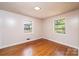 Bedroom with hardwood floors and natural light from two windows at 542 9Th Nw St, Hickory, NC 28601