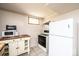 Kitchen area featuring white appliances, wood cabinetry, and tile floor at 542 9Th Nw St, Hickory, NC 28601