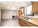 Kitchen area with wood cabinets, stainless steel sink, and tile floors at 542 9Th Nw St, Hickory, NC 28601