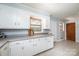 Kitchen with white cabinets, tile floor, neutral counter tops, and open doorway at 542 9Th Nw St, Hickory, NC 28601