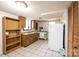 Kitchen featuring wood cabinets, microwave, refrigerator, and tile flooring at 542 9Th Nw St, Hickory, NC 28601
