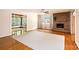 Spacious living room featuring hardwood floors, large windows, and a stone fireplace at 542 9Th Nw St, Hickory, NC 28601