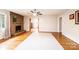 Bright living room with a stone fireplace, hardwood floors, and a ceiling fan at 542 9Th Nw St, Hickory, NC 28601