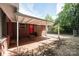 Brick home featuring a covered patio with a tile floor and a view of the fenced yard at 542 9Th Nw St, Hickory, NC 28601
