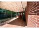 Covered patio with brick and tile, offering an outdoor space that blends with the home's exterior at 542 9Th Nw St, Hickory, NC 28601