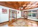 Bright sunroom with a striking wood ceiling, hardwood floors, and large windows with a view at 542 9Th Nw St, Hickory, NC 28601