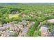 Aerial view of a neighborhood near a golf course, featuring lush green trees and varying home styles at 6133 Wakehurst Rd, Charlotte, NC 28226