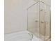 Bathroom showcasing a bathtub with showerhead and glass door at 6133 Wakehurst Rd, Charlotte, NC 28226