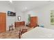 Spacious bedroom with wood furnishings, television, and natural light from the window at 6133 Wakehurst Rd, Charlotte, NC 28226