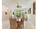 Bright dining room features a large window, elegant lighting, and a classic table with seating for six at 6133 Wakehurst Rd, Charlotte, NC 28226