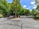 Gated entrance to a residential community surrounded by lush trees, enhancing privacy and security at 6133 Wakehurst Rd, Charlotte, NC 28226