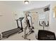 Dedicated home gym equipped with treadmill, weight machine, and stationary bike at 6133 Wakehurst Rd, Charlotte, NC 28226