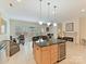 Open-concept kitchen featuring a wine fridge, granite countertops, and a seamless flow to the living area with fireplace at 6133 Wakehurst Rd, Charlotte, NC 28226