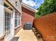 Private outdoor patio featuring red brick walls and a covered grill, perfect for grilling and relaxing at 6133 Wakehurst Rd, Charlotte, NC 28226