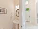 Charming powder room with pedestal sink and decorative lighting fixtures at 6133 Wakehurst Rd, Charlotte, NC 28226