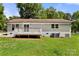 View of the house from backyard with deck and well-maintained grassy lawn at 7141 Pitchfork Ln, Mint Hill, NC 28227