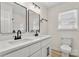 This bathroom features a dual sink vanity, black hardware and a window to let in the light at 7141 Pitchfork Ln, Mint Hill, NC 28227