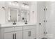 This bathroom features a dual sink vanity, black hardware and a window to let in the light at 7141 Pitchfork Ln, Mint Hill, NC 28227