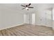 This bedroom features light neutral walls, updated flooring and multiple doors at 7141 Pitchfork Ln, Mint Hill, NC 28227