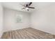 This bedroom has a ceiling fan, light neutral walls, updated flooring and a window to let in the light at 7141 Pitchfork Ln, Mint Hill, NC 28227