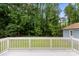 White wooden deck overlooking a green, grassy backyard and mature trees at 7141 Pitchfork Ln, Mint Hill, NC 28227