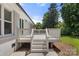 Back deck with stairs leading to the backyard and exterior view of home at 7141 Pitchfork Ln, Mint Hill, NC 28227