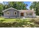 Charming home featuring a mix of gray siding and white brick with wood shutters, complemented by a well-maintained lawn at 7141 Pitchfork Ln, Mint Hill, NC 28227