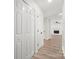 Hallway featuring wood look flooring, a ceiling light, and access to a living room at 7141 Pitchfork Ln, Mint Hill, NC 28227